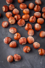 fresh natural hazelnuts on a dark stone background