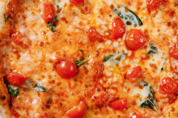 Italian pizza with tomatoes, spinach and cheese close-up. Italian fast food delivery.