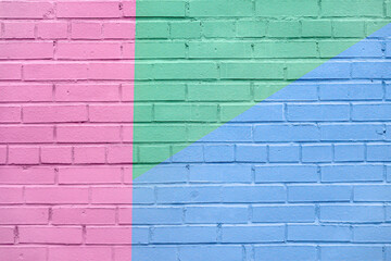 Brick wall decorated with of colorful colors. Geometric detail of a graffiti. Abstract bright background