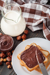toasts with chocolate butter on a dark wooden rustic background