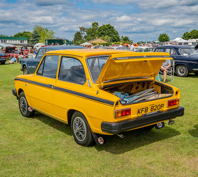 Wroxham, Norfolk, UK &ndash; July 21 2019. An illustrative editorial photo of a bright yellow classic Volve car on show at a free to enter car show