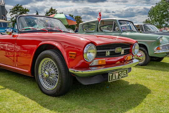 Wroxham, Norfolk, UK – July 21 2019. An illustrative editorial photo of a front on view of a red Triumph TR6 on show at a free to enter car show