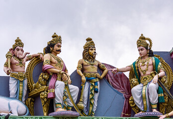 Obraz na płótnie Canvas Kadirampura, Karnataka, India - November 4, 2013: Sri Murugan Temple. Colorful statues, closeup of Surapadman being lectured by emissionary with his 2 brothers Singamukhan and Gajamukhan behind him