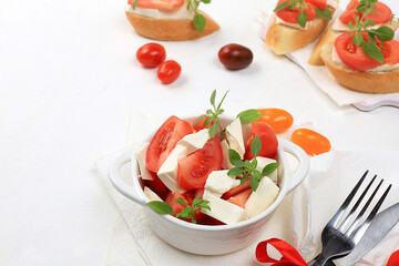 Caprese and toast with mozzarella cheese, cherry tomatoes and fresh garden Basil.Traditional Italian food, healthy natural Breakfast, cholesterol-free and GMO-free, space for text,