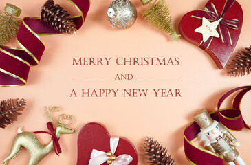 Fototapeta na wymiar Luxury Christmas background with on trend fashionable stylish coral, deep red and gold gifts and decorations. Top view creative composition flat lay. Merry Christmas and Happy New Year text greeting.