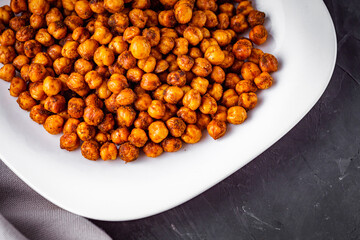 fried chickpeas on a dark stone background