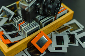 35mm Slide-Photos, An old analog camera and a wooden box with slides, out of focus, dias