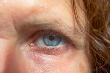 Closeup of blue eye, caucasian middle aged woman