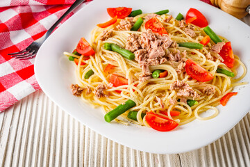 delicious traditional Italian pasta with tuna on a white rustic wooden background