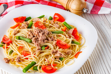 delicious traditional Italian pasta with tuna on a white rustic wooden background