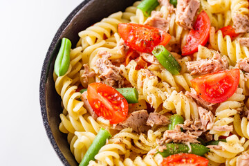 delicious traditional Italian pasta with tuna on a white background