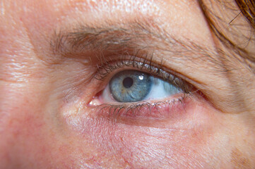 Blue eye on the woman's face. Macro.