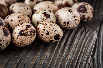 fresh quail eggs on a dark wooden rustic background