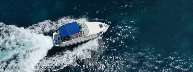 Fototapeta premium Aerial drone ultra wide panoramic photo of luxury yacht cruising in high speed in open ocean deep blue sea