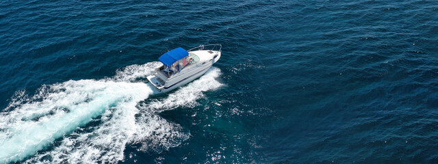 Fototapeta premium Aerial drone ultra wide panoramic photo of luxury yacht cruising in high speed in open ocean deep blue sea