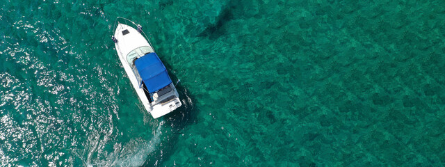 Fototapeta na wymiar Aerial drone ultra wide panoramic photo of luxury yacht cruising in low speed in open ocean deep blue sea
