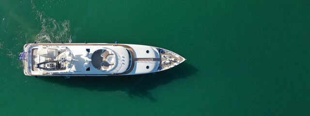 Aerial drone top down ultra wide panoramic photo of luxury yacht anchored in Mediterranean port