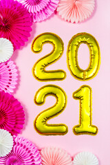 2021 numbers. Round pink paper decoration Happy New Year party background. Golden metallic foil balloons above. Christmas holiday greeting decor. Banner, postcard template, bright pastel wallpaper