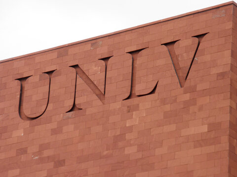 UNLV Logo on side of Red Brick building