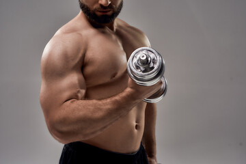 Figure of young muscular caucasian athlete lifting dumbbell