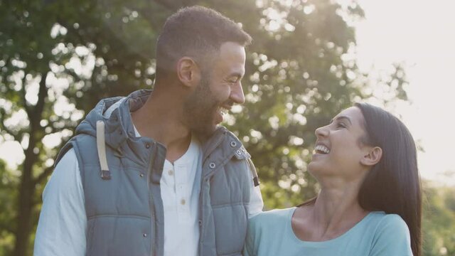Portrait of loving couple in countryside against flaring sun - shot in slow motion