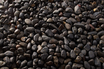 Black Pebbles close up macro detail round river bed drift rock flatlay background dark moody