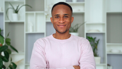 Confident smiling young african businessman looking at camera in office