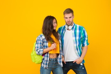 Millennial couple of sexy woman looking with love on handsome man in casual fashion style yellow background, modern
