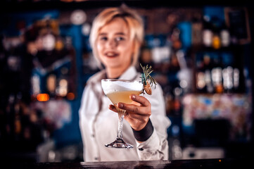 Girl barman concocts a cocktail in the saloon