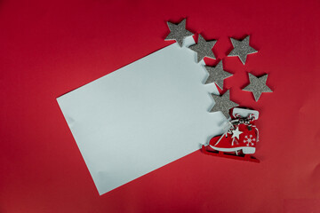 New Year's decor on a red background. Christmas, holiday, give, count days, frame. flatlay. white sheet of paper, frame