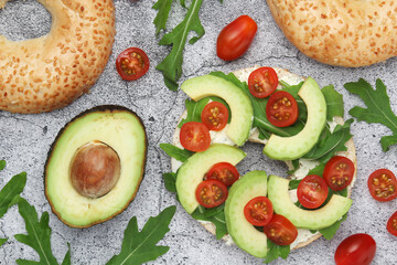 Sesame bagels with tomatoes and avocado