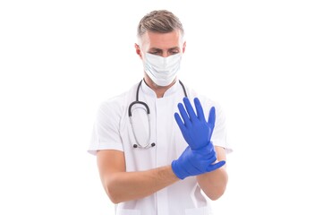man doctor therapist with stethoscope wearing respirator mask and surgical gloves during coronavirus pandemic outbreak isolated on white, family doctor
