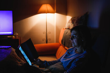 adult woman using a touch tablet in the living room