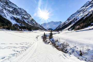 Fototapeta na wymiar Cross-country skiing trail through the Pitztal near Sankt Leonhard in Tirol, winter sports in snowy landscape in the Austrian Alps, Austria Europe