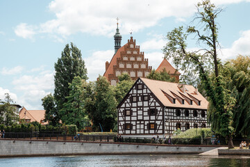 Fototapeta na wymiar Travel to Bydgoszcz. Architecture of Bydgoszcz. Houses and churches of the city in Poland. Historic 18th-century granaries on the Brda River. White Granary on the river.
