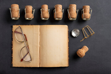 Old yellowed notebook and champagne corks. A place to save your memories of New Year's Eve.