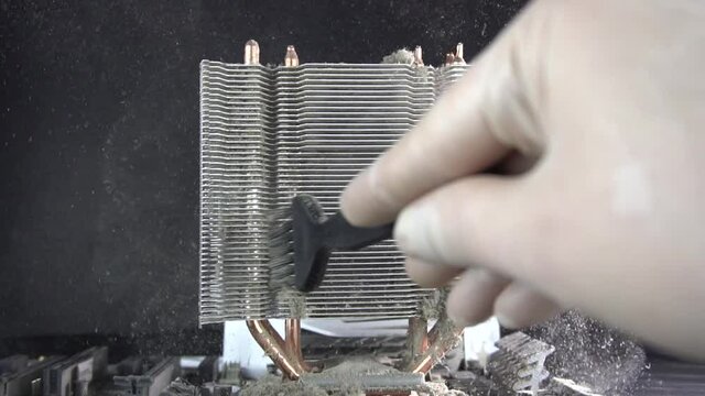 Dust pollution. Cleaning the processor radiator sink from dust. Antistatic brush. Slow motion.