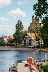 Architecture of Bydgoszcz. Houses and churches of the city in Poland. Pier with catamarans and...
