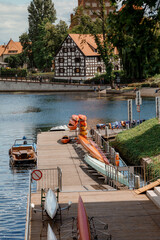 Architecture of Bydgoszcz. Houses and churches of the city in Poland. Pier with catamarans and...
