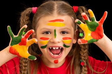 A little girl in paint is trying to scare you.