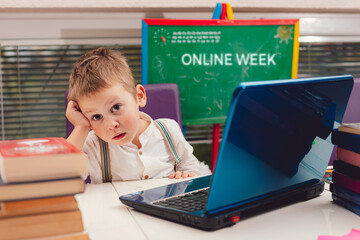 Cute boy is bored on online class, online school covid-19