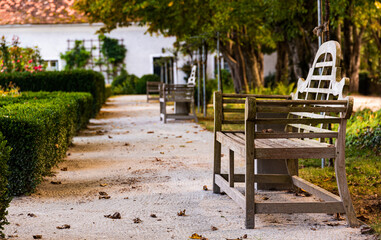 Fototapeta na wymiar Schloss Herberstein, empty bench in garden in autumn, travel destination in Styria Austria .