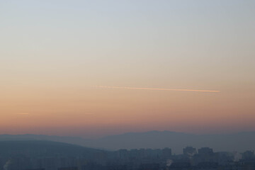 Beautiful evening sky on the city and mountains