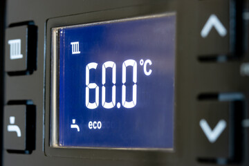 Control panel with display of the working gas boiler for hot water and heating. The smart control panel household gas boiler, close up.