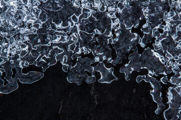 Close-up ice crust on black background