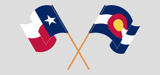 Crossed and waving flags of The State of Colorado and The State of Texas