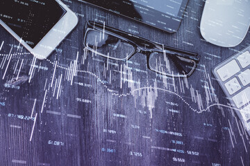 Multi exposure of forex graph hologram over desktop with phone. Top view. Mobile trade platform concept.
