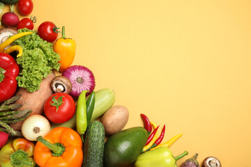 Flat lay composition with fresh vegetables on yellow background. Space for text