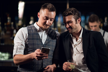 male friends call from a video from a nightclub.