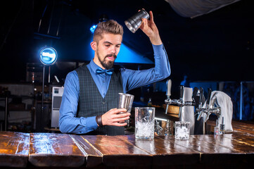 Barman makes a cocktail at the alehouse